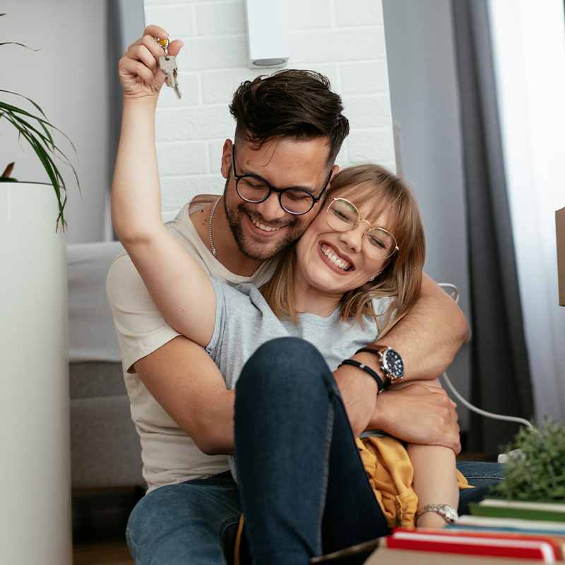 Happy couple is unpacking their belongings at new house