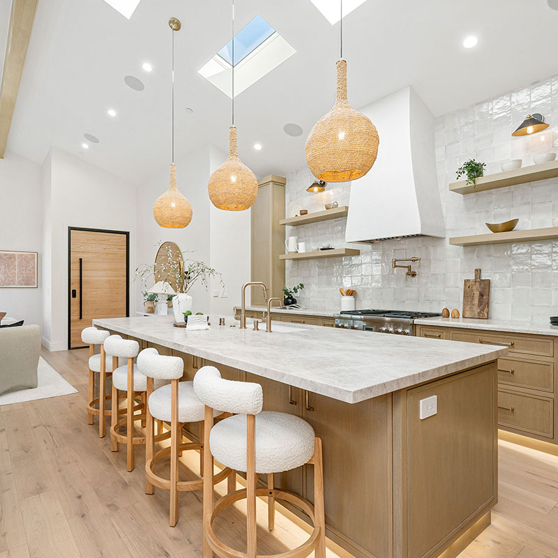 Modern kitchen interior with wooden cabinets, island, and pendant lights