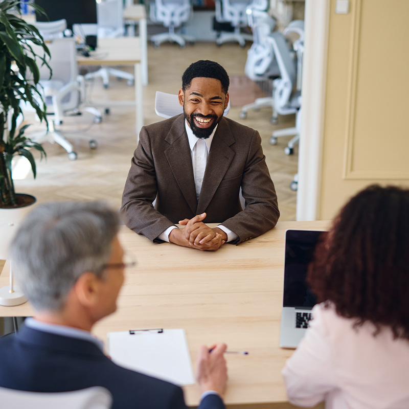 Smiling manager having a job interview with two recruiters